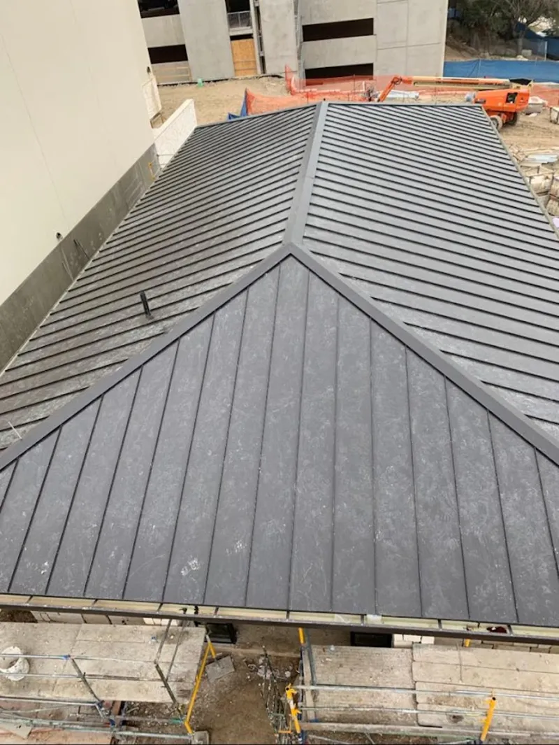 Commercial metal roof construction with crane equipment in Santa Rosa